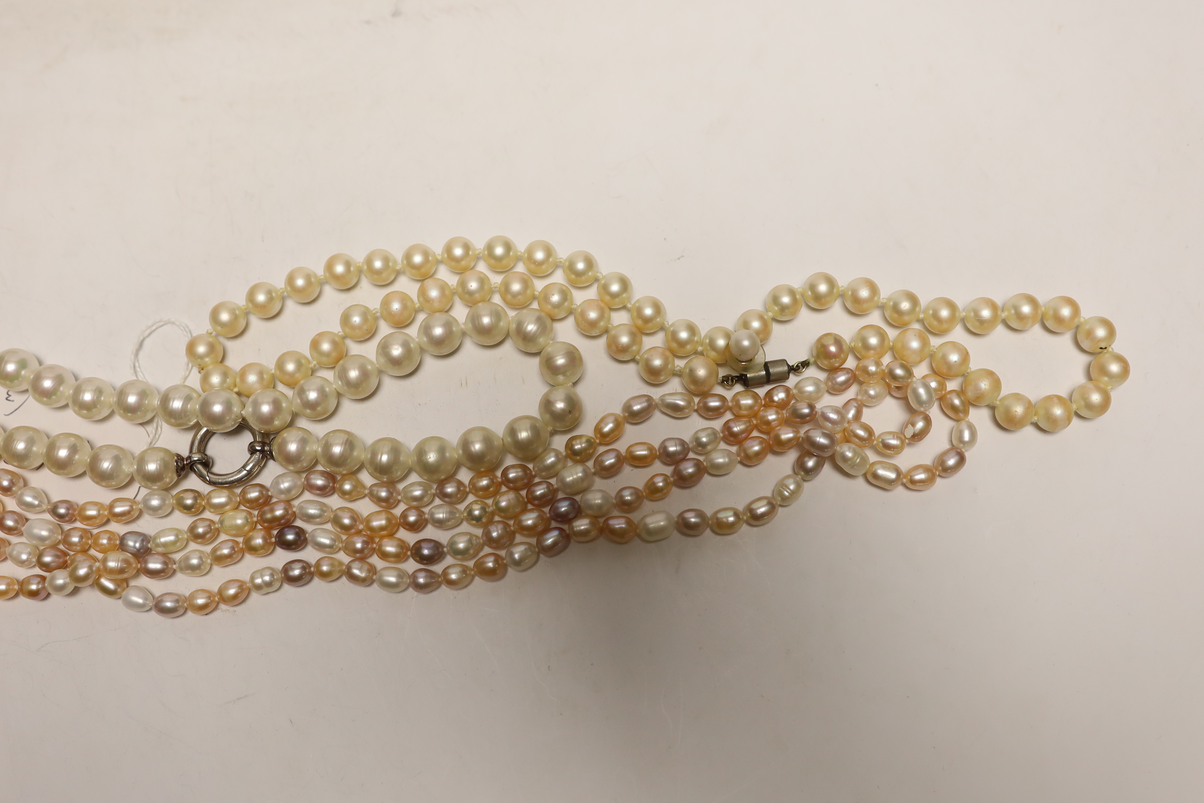 Three assorted single strand cultured South Sea pearl necklaces, largest 136cm.